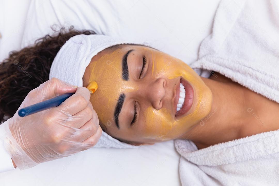 mulher está deitada no consultório do cosmetologista sobre o procedimento de hidratação do rosto