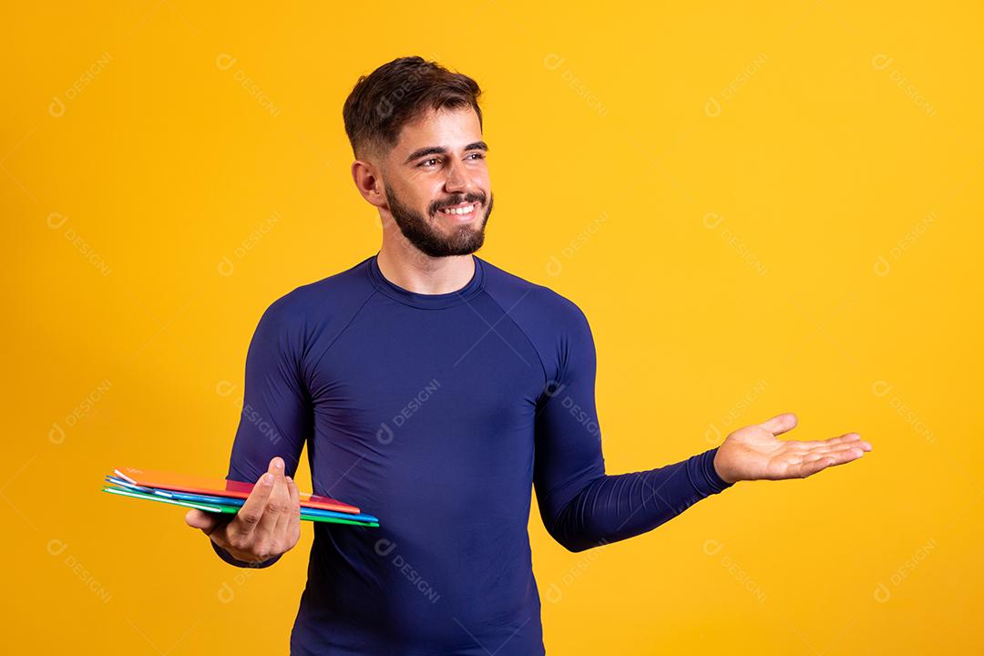 Menino jovem estudante sobre fundo amarelo. menino estudante feliz