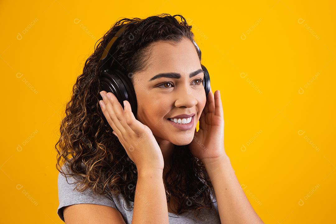 jovem afro com seus fones de ouvido ouvindo música.