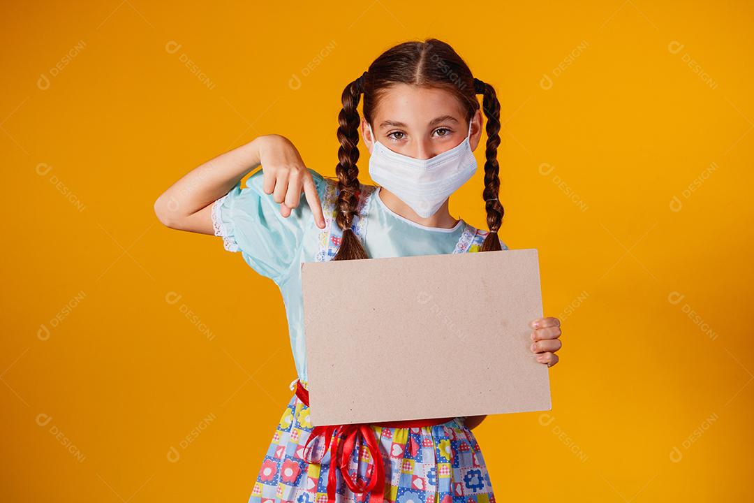 Criança com roupas típicas da famosa festa brasileira chamada Festa Junina em comemoração ao São João