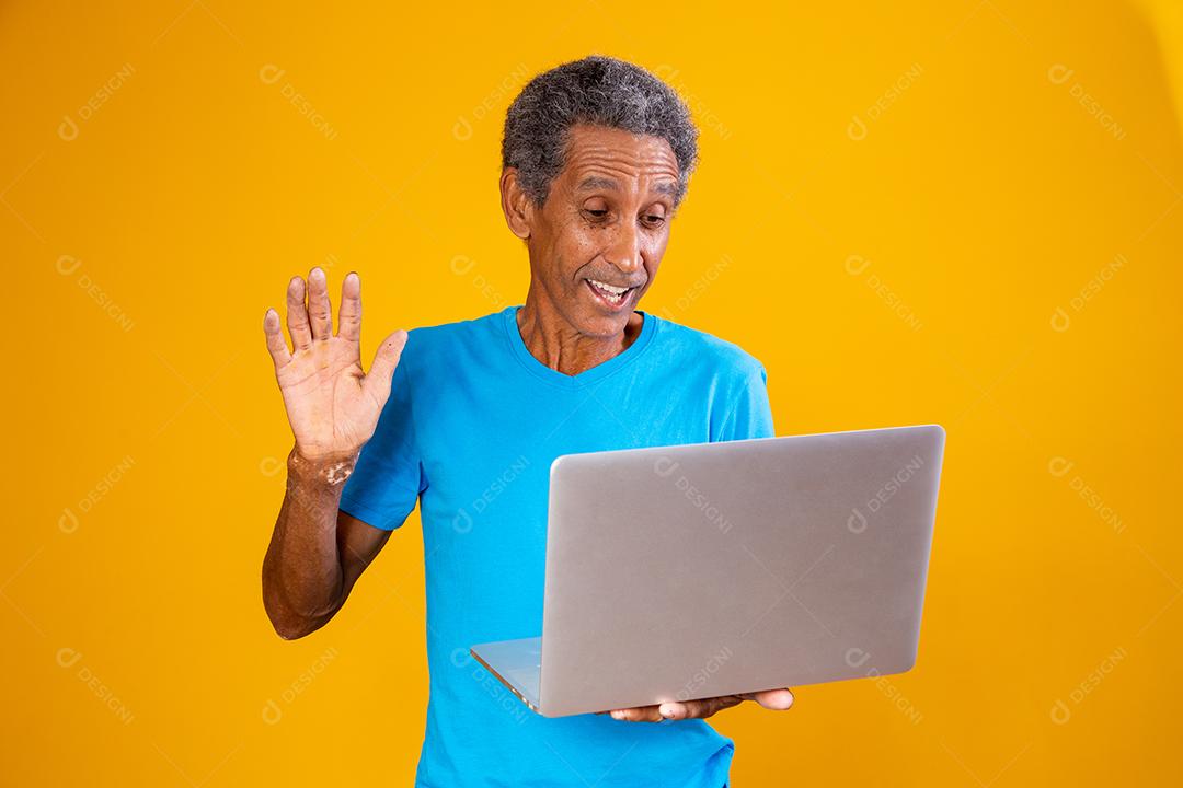 elderly man with laptop on video conference