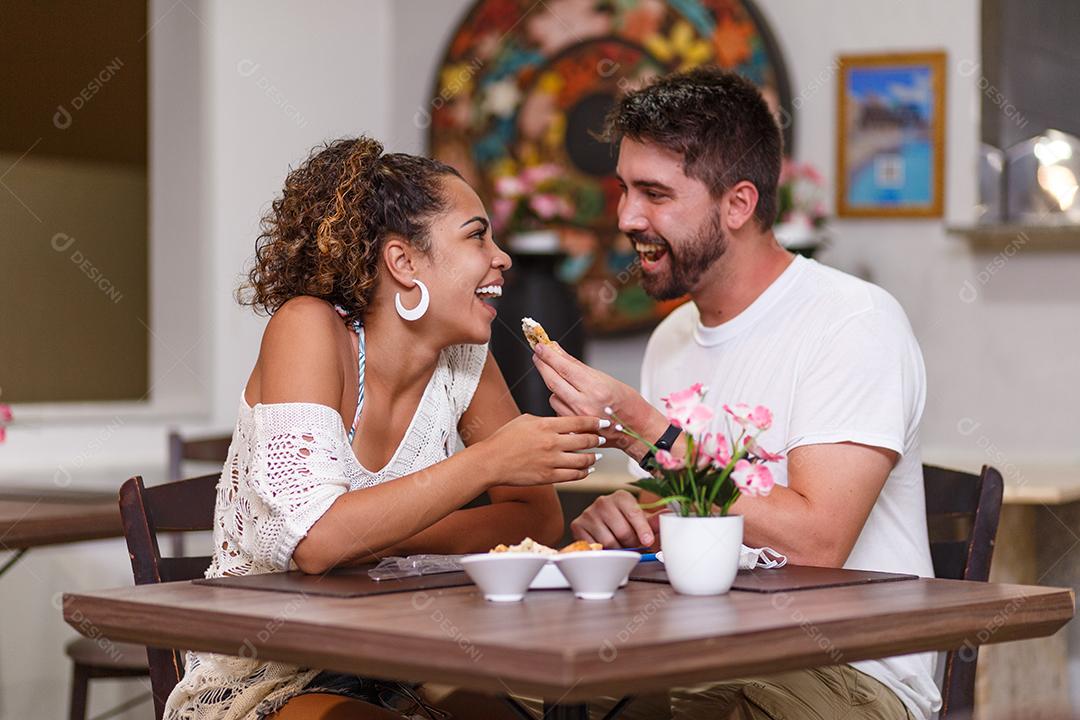 jovem casal de amantes jantando no restaurante.