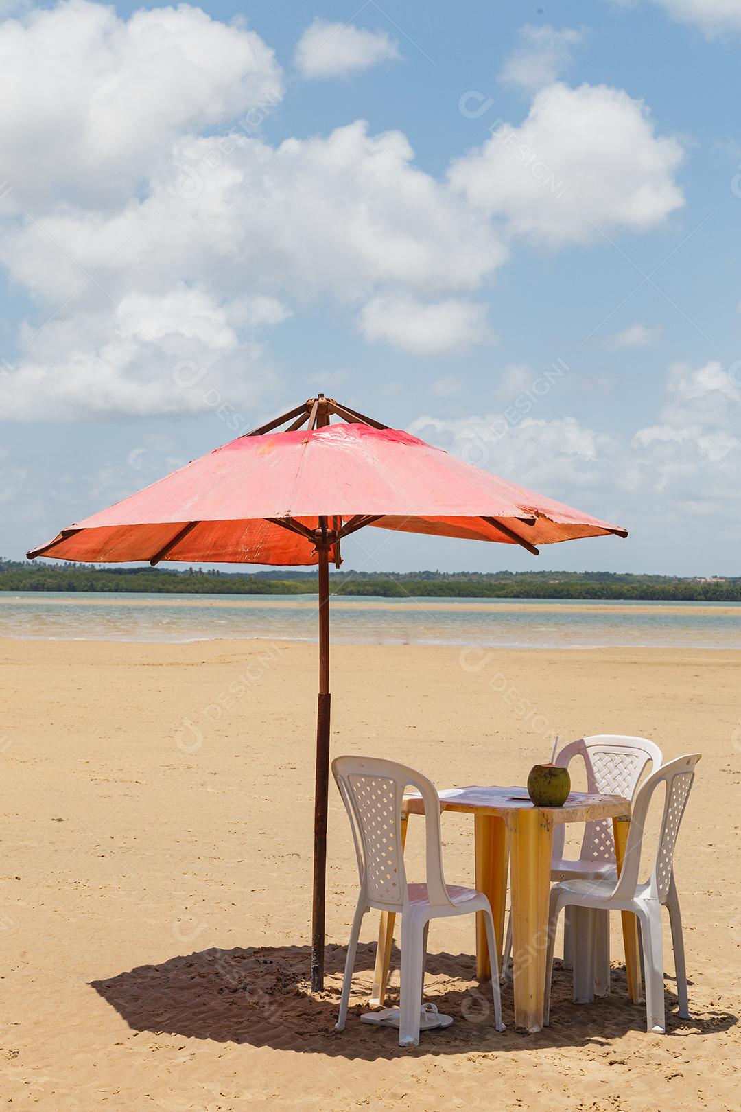 photo of chairs and umbrella with a lake in the background. Beach, vacation and summer