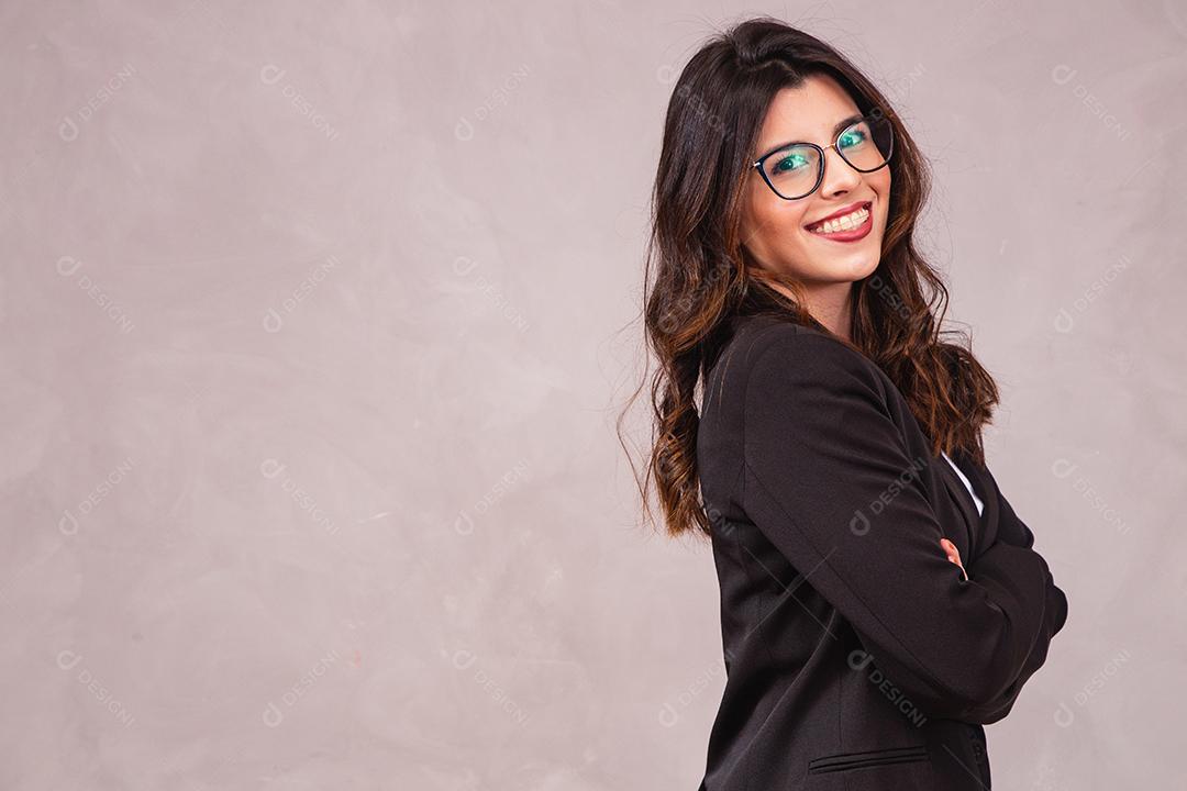 Smiling brunette woman without glasses posing with arms crossed