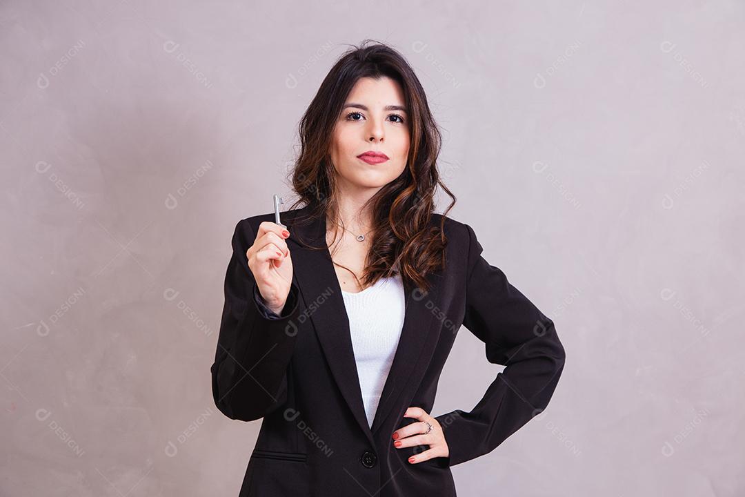 Mulher bonita de blazer preto em fundo cinza