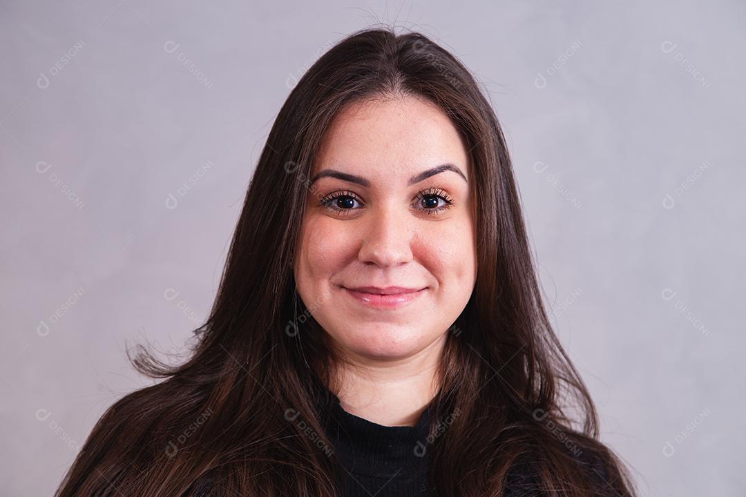 Mulher bonita de blazer preto em fundo cinza