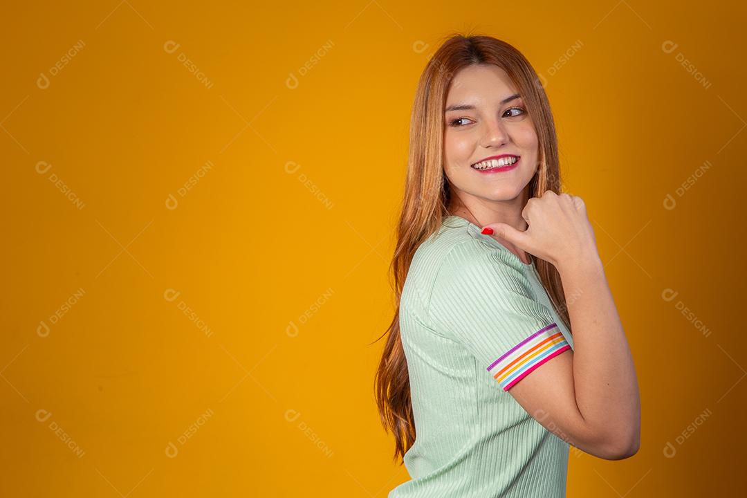 Jovem ruiva sorrindo com mão no queixo