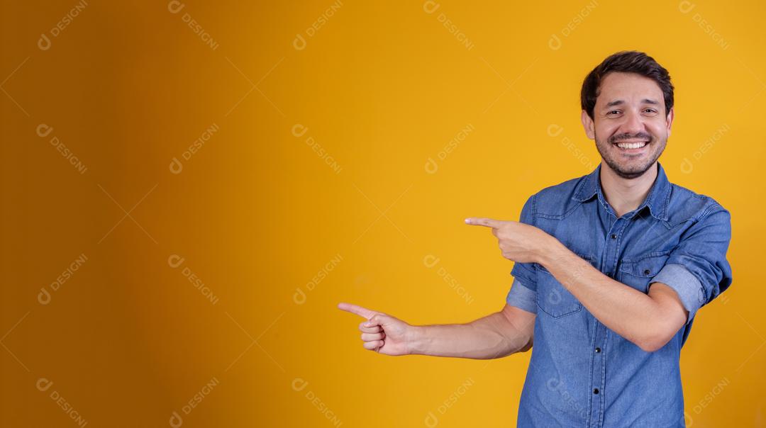 Homem brasileiro apontando para o lado com as duas mãos