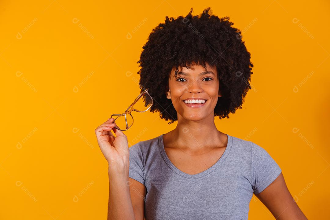 mulher afro com óculos sorrindo para a câmera