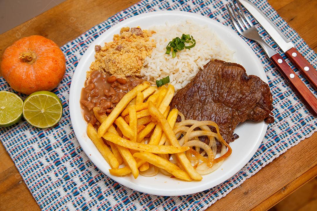 Plate of rice, beans, french fries and steak