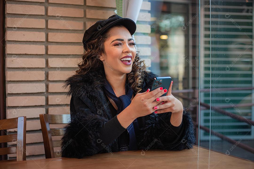 Mulher Afro usando celular para trabalhar