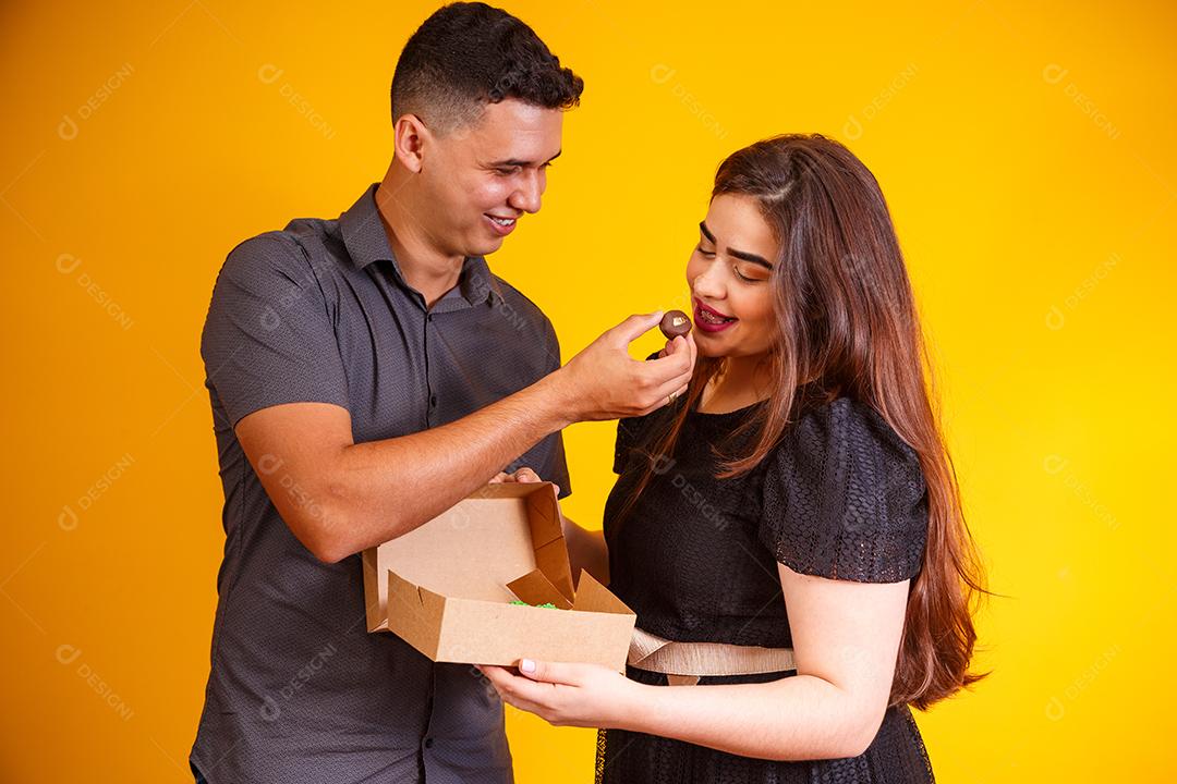 Casal de namorados com caixa de doces fazendo surpresa