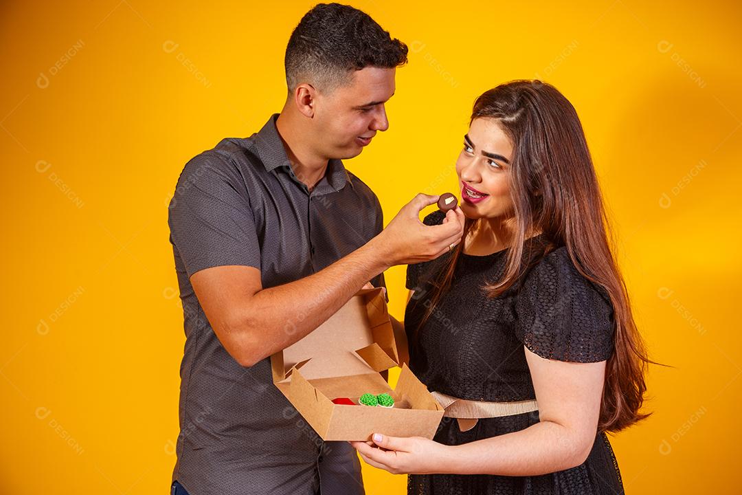 Casal de namorados com caixa de doces fazendo surpresa