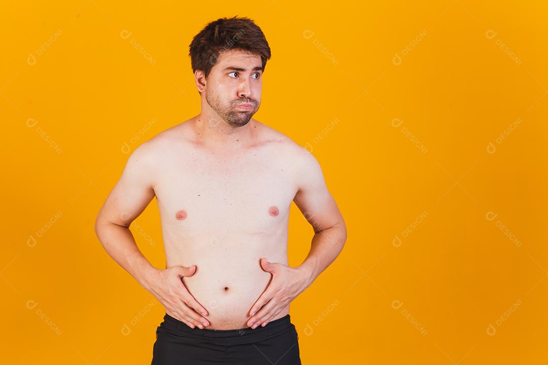 Homem tocando sua barriga gorda Mão de homem obeso segurando a gordura da barriga excessiva