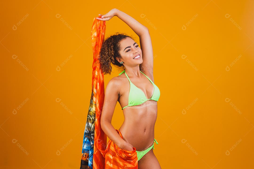 Woman in green bikini beachwear on green background