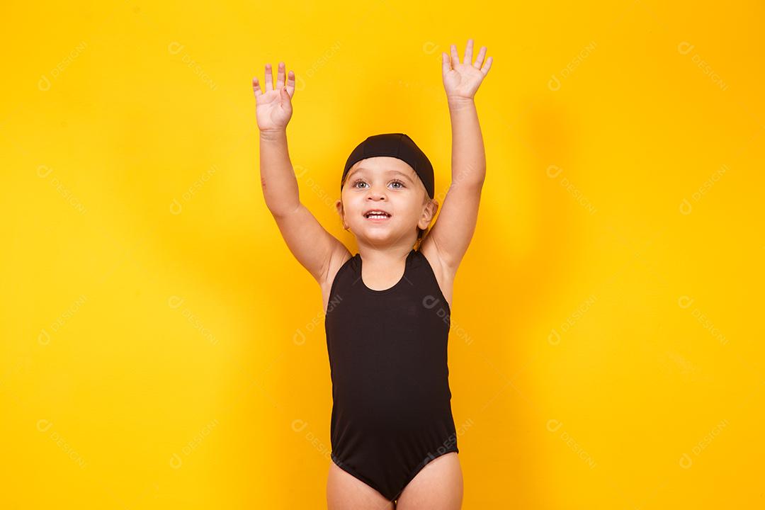 Menina vestindo roupa de praia em fundo amarelo. Conceito de verão e férias