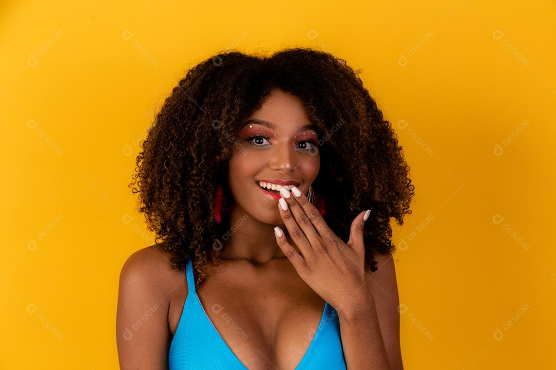 Linda garota afro com cabelo encaracolado e sorriso de biquíni para a câmera