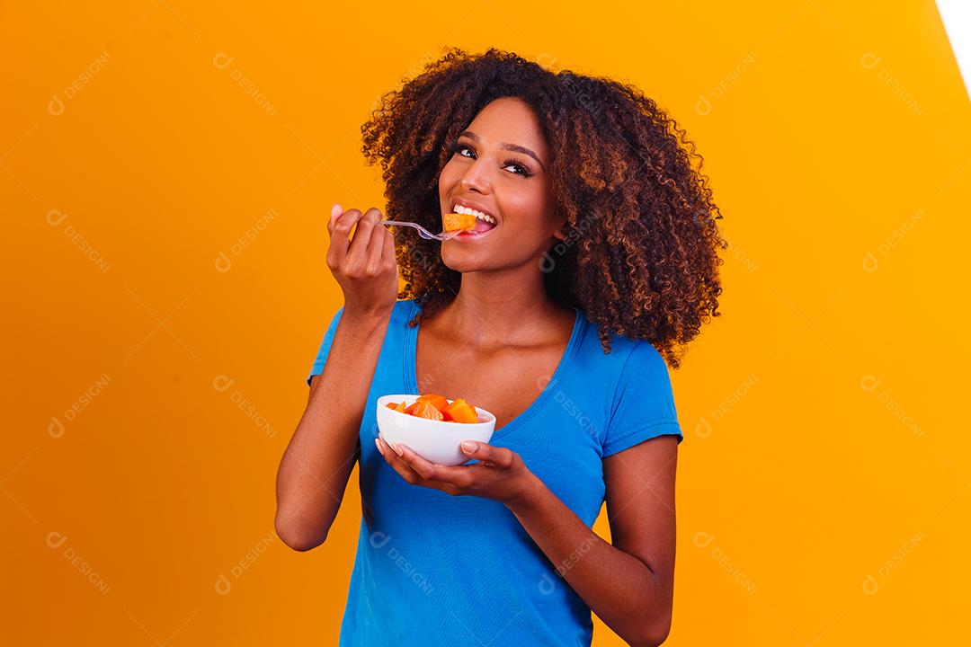 linda mulher comendo mamao sobre tigela fotos imagem