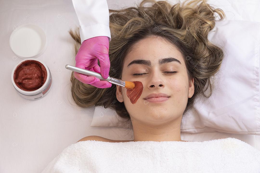 mulher deitada em maca em clinica de estética