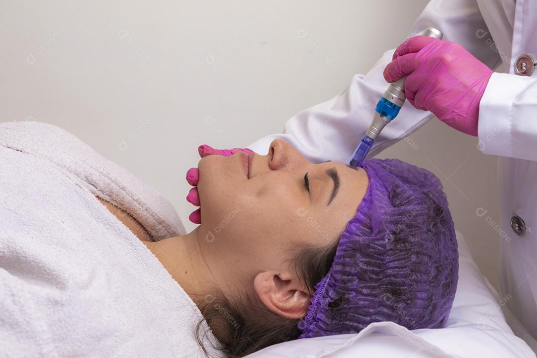 Jovem deitada na mesa do cosmetologista durante o rejuvenescimento p