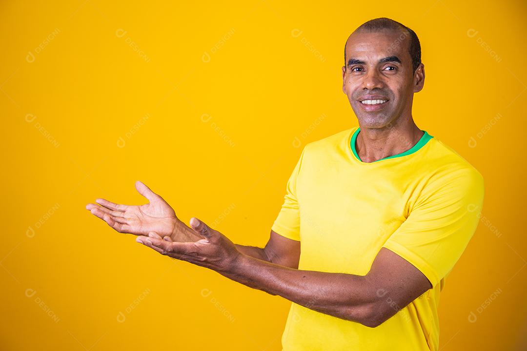 handsome afro brazilian man pointing to side in free space