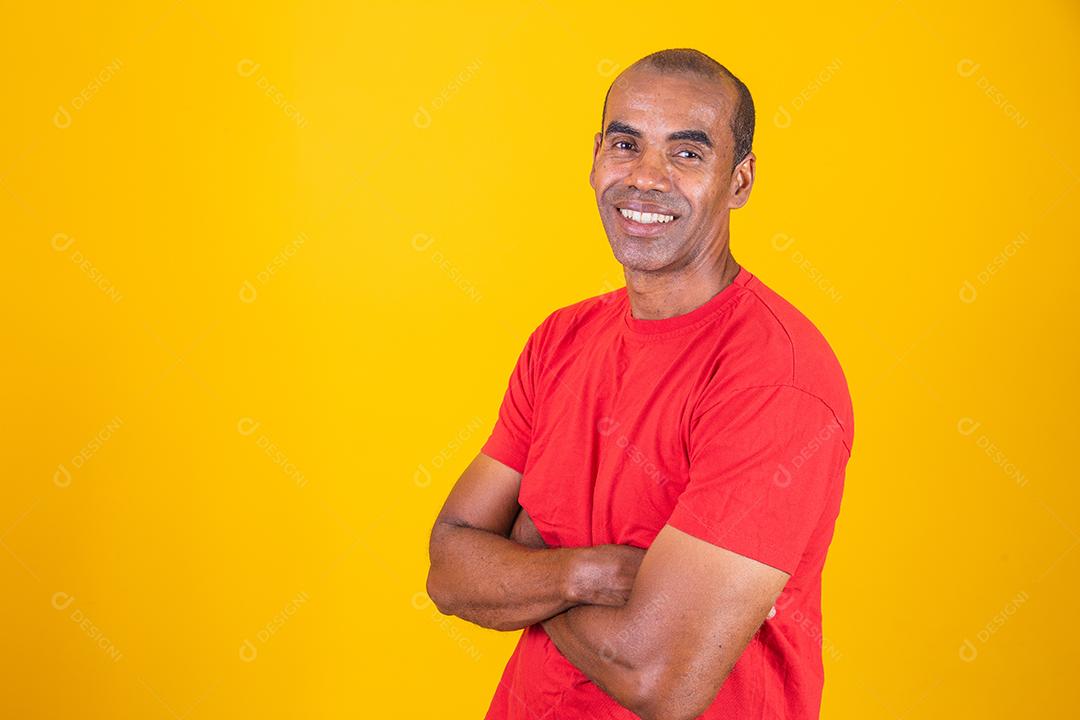 Older black man crossing his arms with confidence. optimistic, happy afro man with arms crossed