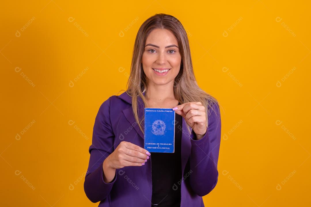 Mulher loira segurando uma carteira de trabalho da previdencia social