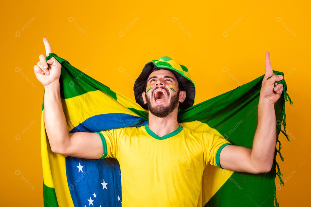 Homem jovem torcedor brasileiro com bandeira do brasil