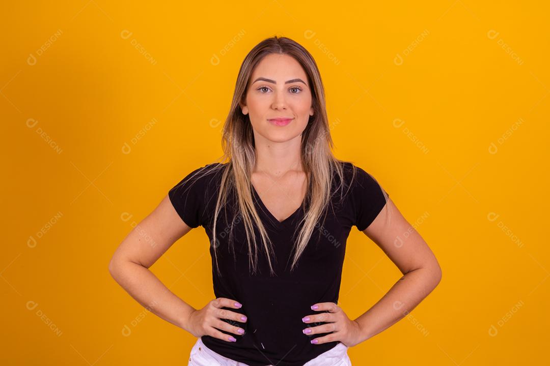blonde white woman dressed in a black blouse on yellow background