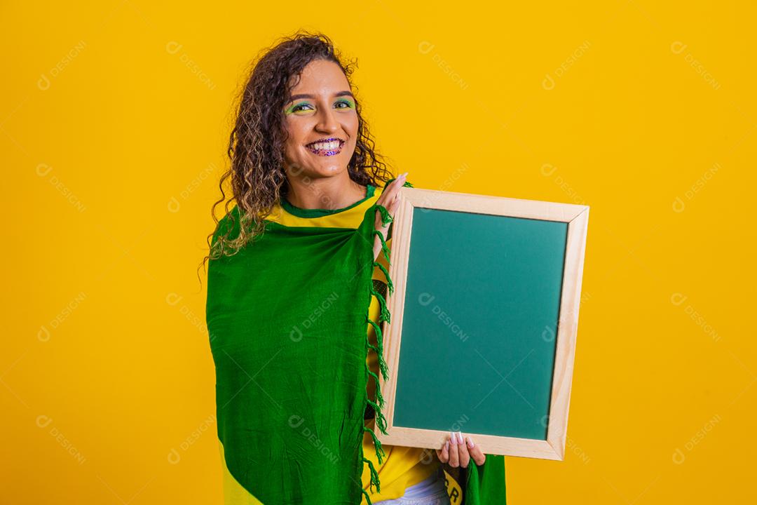Fã brasileiro segurando uma lousa em branco para espaço de texto. mundo