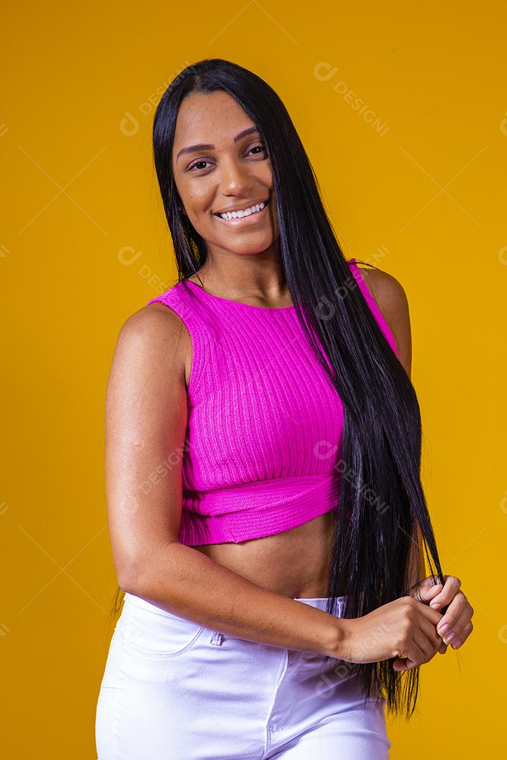 Bela jovem morena com cabelo comprido sorrindo olhando para a câmera