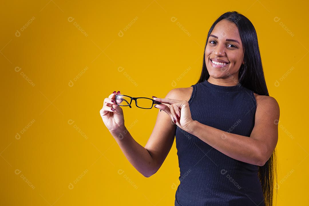 Garota positiva e sorridente segurando óculos.