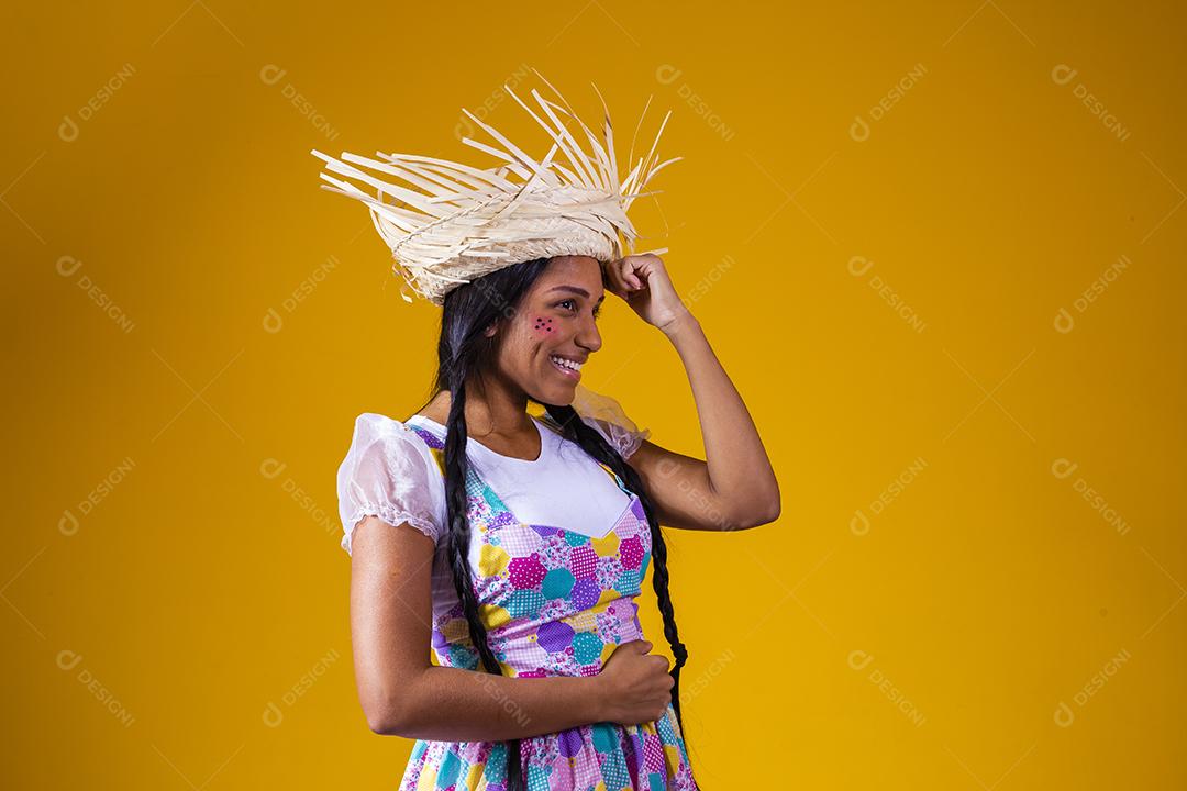 Garota vestida com roupas típicas para a festa junina brasileira dançando