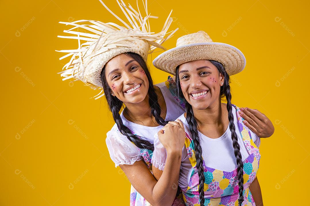 lindas irmãs gêmeas com roupas típicas de festa junina.