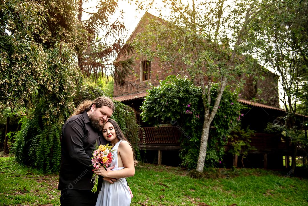 Casal de noivos apaixonado no jardim da casa velha