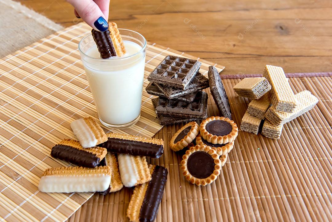 dipping cookies in milk, Various types of biscuits and biscuits, stuffed and homemade with glass of milk