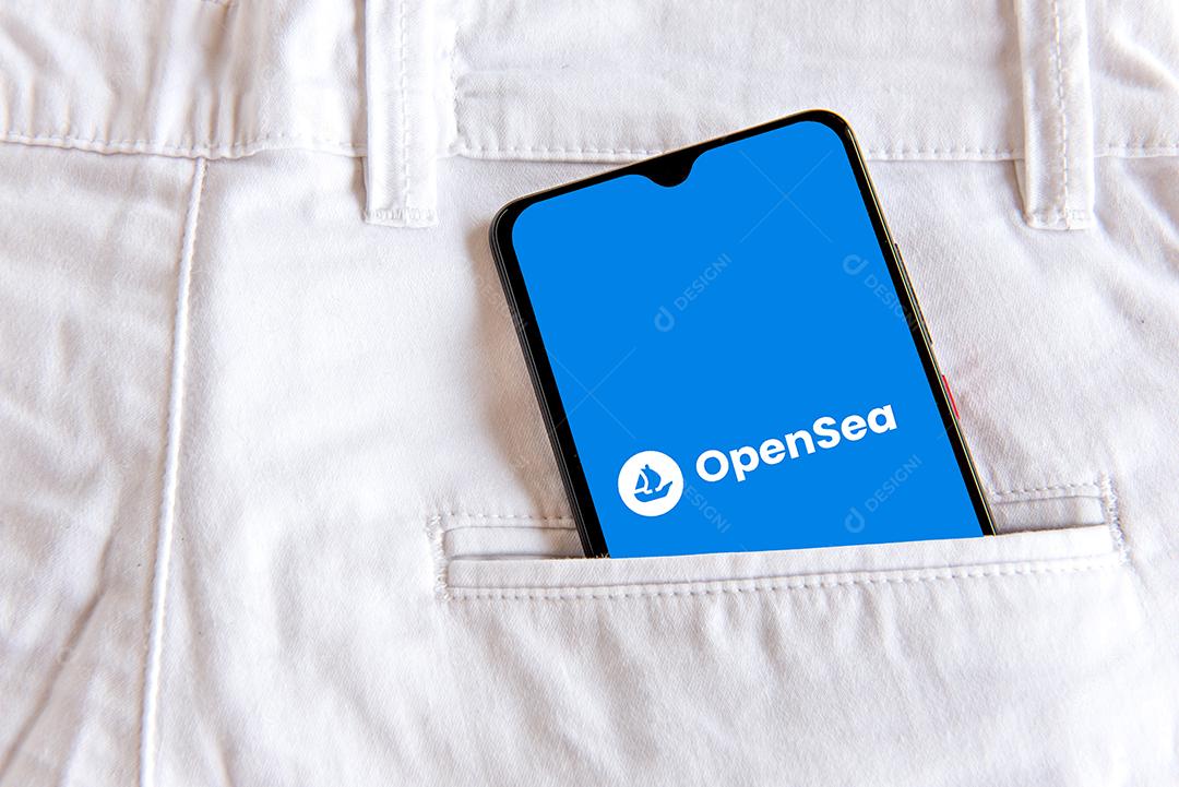 Smartphone com aplicação opensea no bolso da calça jeans branca
