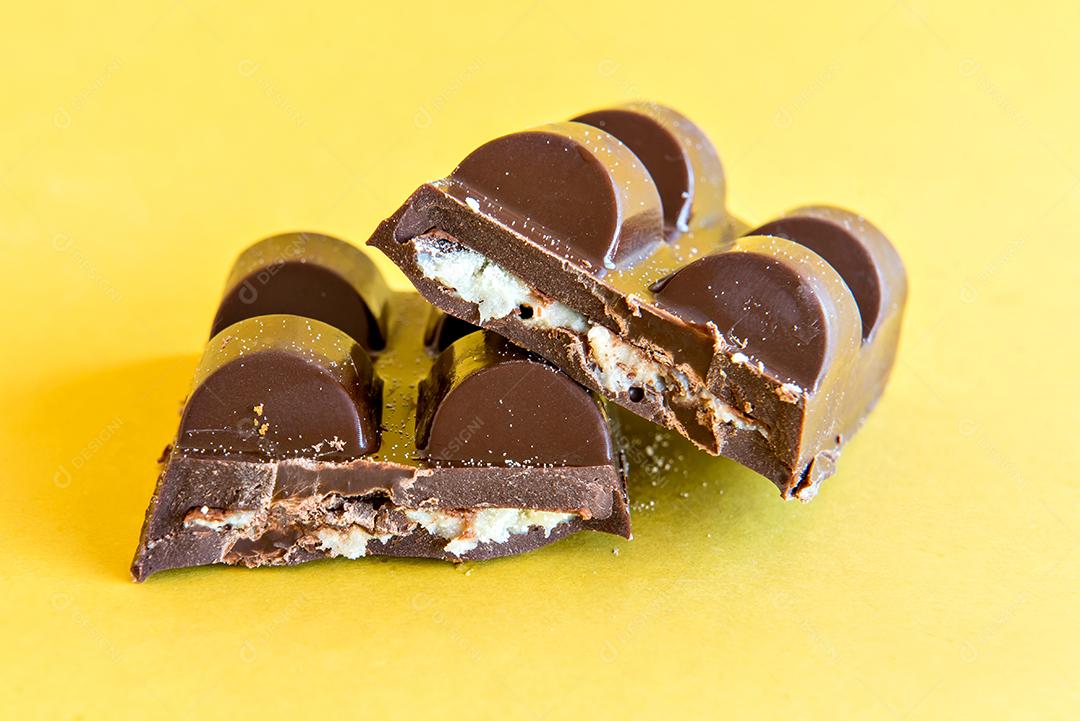 Stuffed chocolate bar on yellow background.