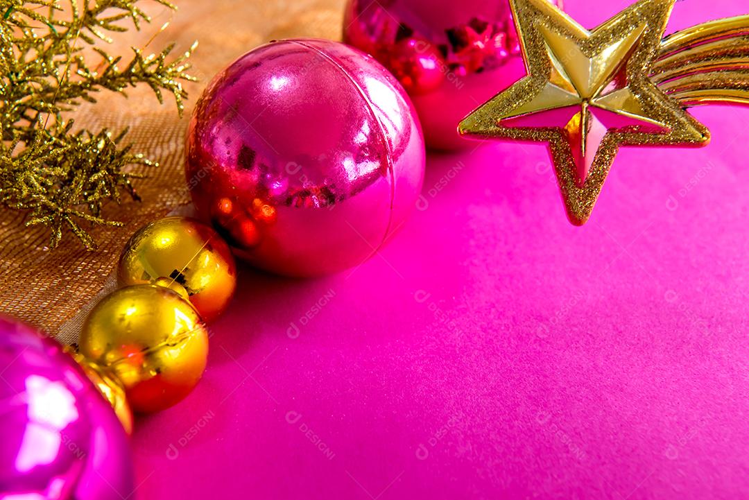 Bolas de natal e enfeites em um fundo rosa