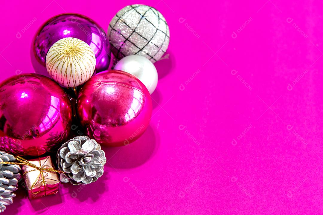 Bolas de natal e enfeites em um fundo rosa