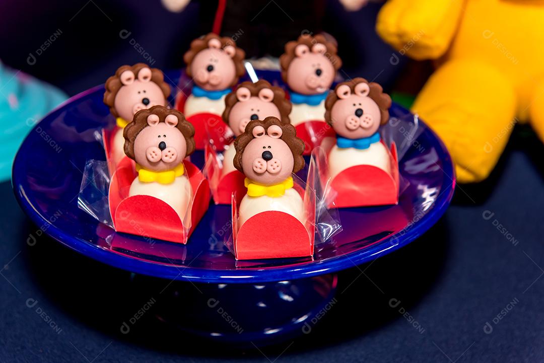 Mesa com doces e muffins decorados com glacê real