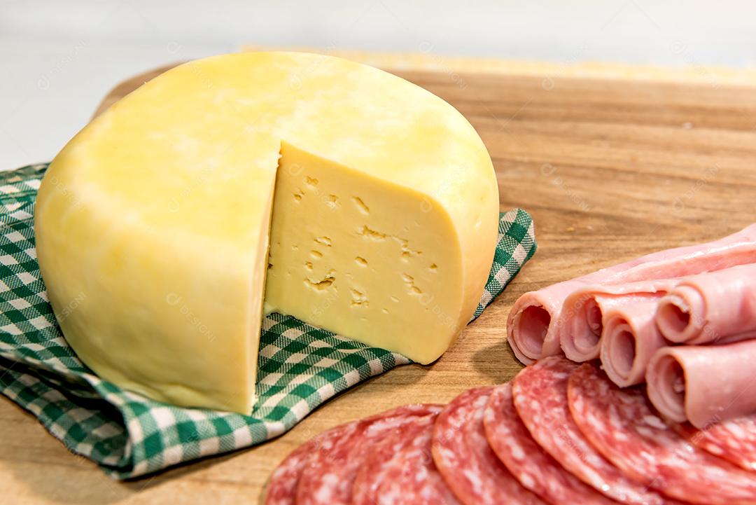 Café da manhã colonial servido com pão, queijo, presunto e salame.