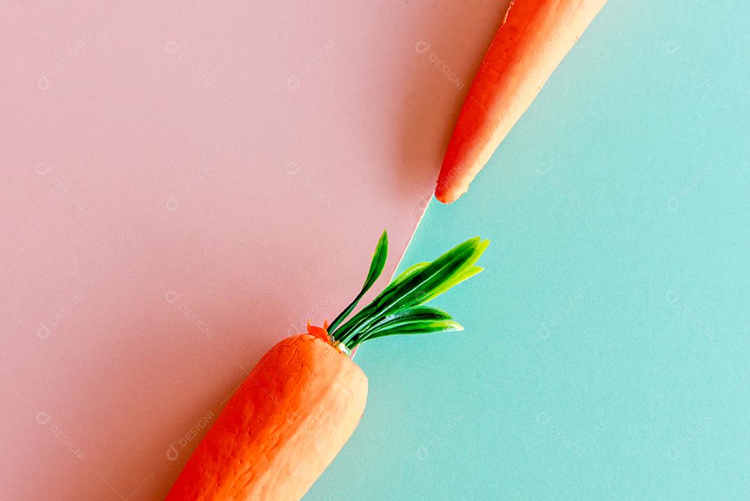 Cenouras em fundo verde e rosa.