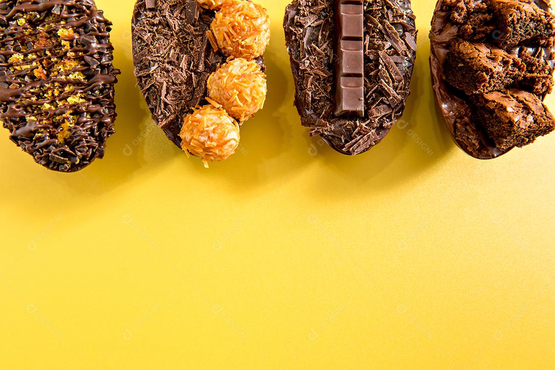 Ovos de páscoa cheios de chocolate em fundo amarelo