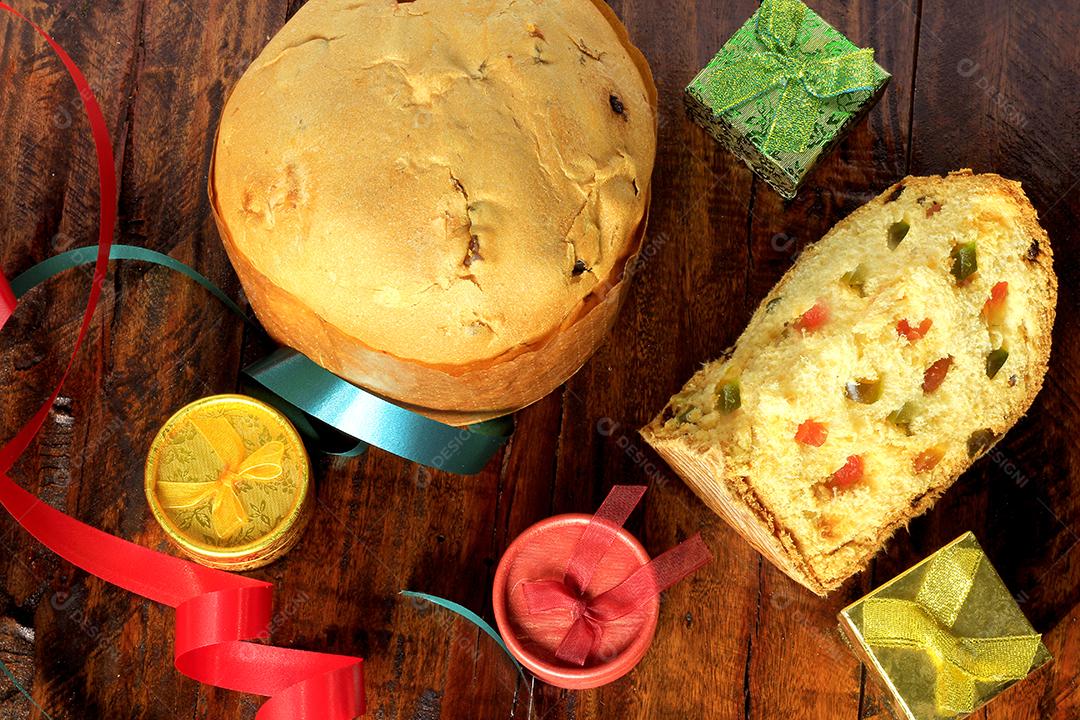 Decoração de natal feita com panetone e presentes isolados em fundo de madeira rústico. vista do topo