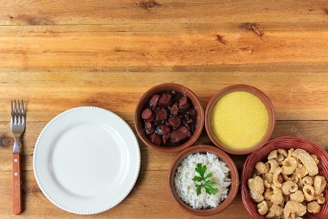 Feijoada brasileira, prato tradicional da culinária brasileira, na mesa de madeira. vista do topo