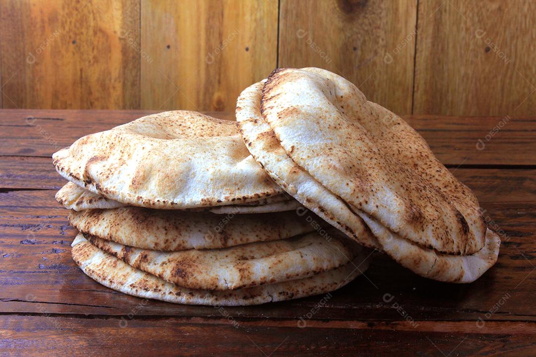 Pão pita isolado na mesa de madeira rústica Comida tradicional e típica da cozinha árabe