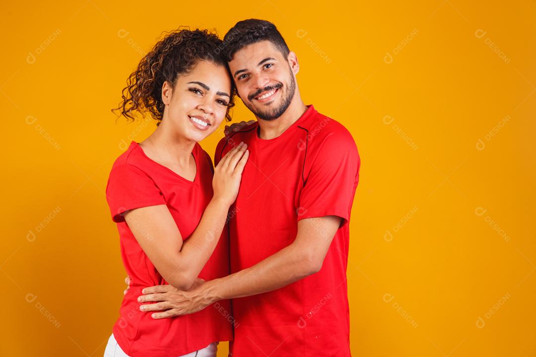 Retrato de casal de conteúdo em roupas básicas sorrindo para a câmera