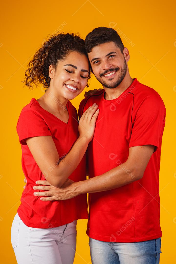 Retrato de casal de conteúdo em roupas básicas sorrindo para a câmera