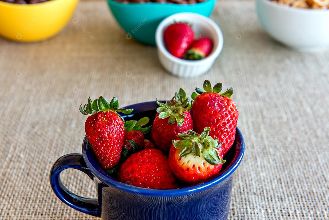 Morangos em um copo azul, café da manhã saudável